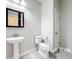 Half bath featuring a pedestal sink, toilet and a decorative mirror at 5647 Barletta Dr, St Cloud, FL 34771
