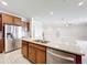 Kitchen island with granite countertop, sink, and stainless steel appliances in modern kitchen at 5647 Barletta Dr, St Cloud, FL 34771