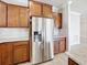 Stainless steel refrigerator with water dispenser, tile backsplash, and plenty of cabinets in kitchen at 5647 Barletta Dr, St Cloud, FL 34771