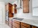 Close-up of kitchen with granite counters, stainless steel range hood, and tile backsplash at 5647 Barletta Dr, St Cloud, FL 34771