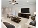 Bright living room with neutral tones, ceiling fan, and dark wood accents at 5647 Barletta Dr, St Cloud, FL 34771
