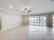 Bright living room featuring recessed lighting, ceiling fan, and sliding glass doors to outdoor space at 5647 Barletta Dr, St Cloud, FL 34771