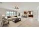 Open floor plan with a spacious living room seamlessly connected to a modern kitchen and dining area at 5647 Barletta Dr, St Cloud, FL 34771