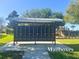 A community mailbox station with a shaded roof and nearby playground at 5647 Barletta Dr, St Cloud, FL 34771