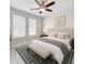 This is a bright bedroom with a queen size bed, a ceiling fan, and two windows for lots of light at 5647 Barletta Dr, St Cloud, FL 34771