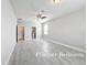 Spacious primary bedroom featuring light gray walls, a ceiling fan and tile flooring at 5647 Barletta Dr, St Cloud, FL 34771