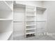 Walk-in closet with custom shelving for optimal organization and plenty of storage space at 5647 Barletta Dr, St Cloud, FL 34771