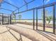 Screened patio with brick flooring, black metal frame and a view of the pond at 5647 Barletta Dr, St Cloud, FL 34771