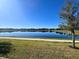 Pond view featuring a walkway and residential homes in the background at 5647 Barletta Dr, St Cloud, FL 34771