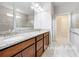 Primary bath with double sink vanity, granite countertop, and a large mirror at 5647 Barletta Dr, St Cloud, FL 34771