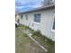 Side exterior view of a modest one-story house showing multiple windows at 5915 Colchester Dr, Orlando, FL 32812