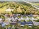 Aerial view of the property featuring mature trees, and a well-manicured lawn at 645 Riverwoods Cir, Orlando, FL 32825