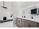 Stylish bathroom with dual sinks, LED mirror, light gray cabinetry, and doorway view to bedroom at 645 Riverwoods Cir, Orlando, FL 32825