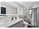 Elegant bathroom featuring a marble shower, quartz countertop, and illuminated mirror with modern fixtures at 645 Riverwoods Cir, Orlando, FL 32825