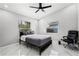 Bright bedroom with marble floors and a modern bed, complemented by two windows for natural light at 645 Riverwoods Cir, Orlando, FL 32825