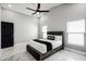 Modern bedroom with marble floors, black door, and comfortable queen-sized bed with stylish black and white bedding at 645 Riverwoods Cir, Orlando, FL 32825