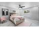 Cozy bedroom featuring marble floors, light pink accents, and bright natural light from two windows at 645 Riverwoods Cir, Orlando, FL 32825