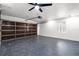 Spacious two-car garage with speckled epoxy flooring, ceiling fan, and automatic door at 645 Riverwoods Cir, Orlando, FL 32825