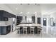 Beautiful open concept kitchen boasts an oversized island, stainless appliances, and stylish dark cabinetry at 645 Riverwoods Cir, Orlando, FL 32825