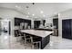 Gorgeous modern kitchen with stainless steel appliances, large center island, and sleek black cabinets at 645 Riverwoods Cir, Orlando, FL 32825