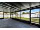 View of the screened patio overlooking manicured yard with white vinyl fence for added privacy at 645 Riverwoods Cir, Orlando, FL 32825