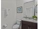 Well-maintained bathroom with granite countertop sink and a decorative painting at 7805 Oak Reflection Loop, Davenport, FL 33837