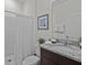 Clean bathroom featuring a shower with white curtain and a granite countertop sink with tasteful decorations at 7805 Oak Reflection Loop, Davenport, FL 33837