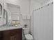 Stylish bathroom with dark wood vanity and granite countertop with neutral decor at 7805 Oak Reflection Loop, Davenport, FL 33837