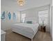 Elegant bedroom with a king bed, shell art, and stylish lighting fixtures at 7805 Oak Reflection Loop, Davenport, FL 33837