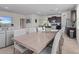 Open-concept dining room with a large table and seating for eight, connecting to the kitchen and living area at 7805 Oak Reflection Loop, Davenport, FL 33837