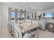 Bright dining room with large windows, modern furniture, and an open layout to the living area at 7805 Oak Reflection Loop, Davenport, FL 33837