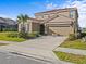 Charming two-story home with a tile roof, green lawn, and attached two-car garage at 7805 Oak Reflection Loop, Davenport, FL 33837