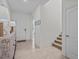 Inviting foyer with tile flooring, a decorative chest, and access to the staircase at 7805 Oak Reflection Loop, Davenport, FL 33837