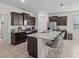 Stylish kitchen featuring dark wood cabinets, granite counters, and barstool seating at 7805 Oak Reflection Loop, Davenport, FL 33837