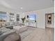 Bright living room featuring neutral décor, large windows, and tiled floors at 7805 Oak Reflection Loop, Davenport, FL 33837