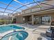 Relaxing backyard pool area with lounge chairs and outdoor dining at 7805 Oak Reflection Loop, Davenport, FL 33837