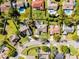 Aerial view of the property in a suburban neighborhood with green lawns and mature trees at 8992 Palos Verde Dr, Orlando, FL 32825