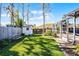 Spacious backyard featuring a white shed, a bench, and a screened in pool area at 8992 Palos Verde Dr, Orlando, FL 32825