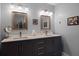 Modern bathroom featuring double vanity, quartz counters, and updated light fixtures at 8992 Palos Verde Dr, Orlando, FL 32825