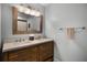 Bathroom featuring a double vanity and a decorative mirror at 8992 Palos Verde Dr, Orlando, FL 32825