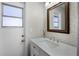 Bathroom features a quartz countertop, white subway tile and a window at 8992 Palos Verde Dr, Orlando, FL 32825