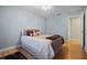 Light blue bedroom featuring wood flooring and bright natural light at 8992 Palos Verde Dr, Orlando, FL 32825