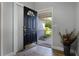 Welcoming entryway with a decorative front door, tiled floor, and view of the front yard at 8992 Palos Verde Dr, Orlando, FL 32825