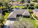 Aerial view of a well-maintained home with mature landscaping and a spacious driveway at 8992 Palos Verde Dr, Orlando, FL 32825