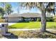 Charming single-story home with a lovely front yard and inviting curb appeal on a sunny day at 8992 Palos Verde Dr, Orlando, FL 32825