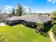 Well-manicured front lawn of a single-story home with lush landscaping and mature trees at 8992 Palos Verde Dr, Orlando, FL 32825