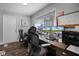 Well-lit home office with dual monitors, wood floors, and white trim creates a functional and aesthetically pleasing workspace at 8992 Palos Verde Dr, Orlando, FL 32825