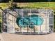 Aerial view of a kidney shaped pool enclosed in a screen, surrounded by a patio and brick pavers at 8992 Palos Verde Dr, Orlando, FL 32825