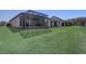 A large grassy backyard with a screen enclosed patio at 9673 Sw 63Rd Loop, Ocala, FL 34481