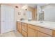 Bathroom features a double vanity with sink, mirror and white wooden cabinets at 9673 Sw 63Rd Loop, Ocala, FL 34481